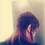 Mandy-Smith-Plastering-bedroom-walls Image of a woman with long hair from the back