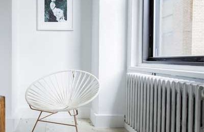 An image showing a newly plastered room and a traditional radiator
