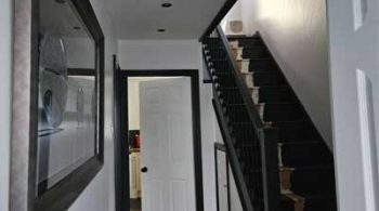 An image of a hall and stairs of a domestic house that has been newly plastered and decorated