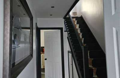 An image of a hall and stairs of a domestic house that has been newly plastered and decorated